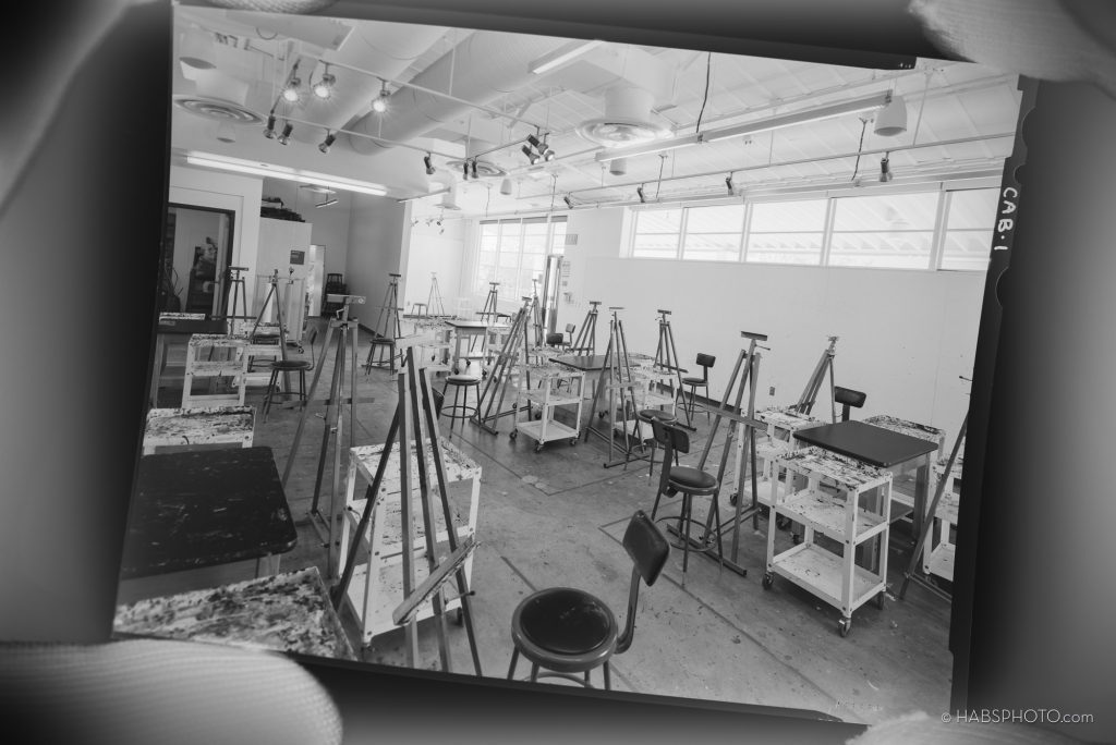 HABS Photograph of a negative of an art classroom in a college with eagles and painting supplies and stools.